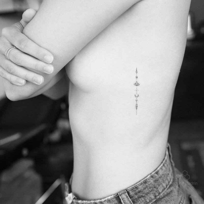 Маленькая тату на ребре у девушек